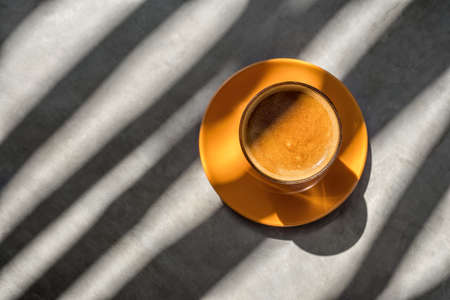 Latte drink in glass on saucerの写真素材