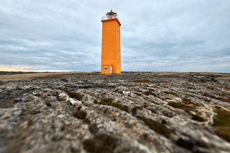 Icelandic landscape with orange lighthouseの写真素材