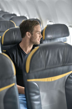 Handsome guy in airplaneの写真素材