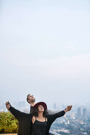 Lovely interracial couple on balconyの写真素材