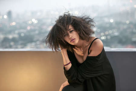 Beautiful girl posing on balconyの写真素材