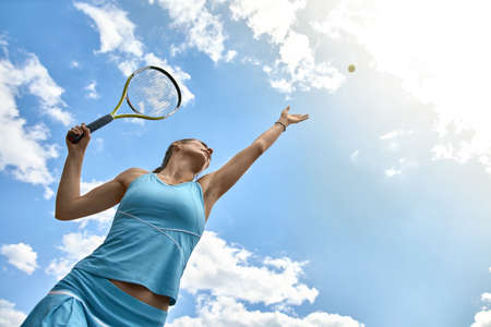 Sportive girl plays tennisの写真素材
