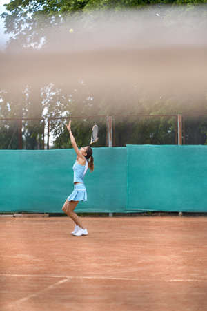 Sportive girl plays tennisの写真素材