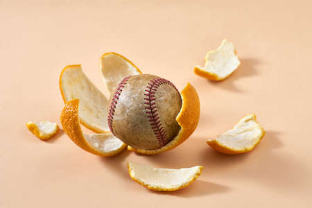 Baseball ball lies on citrus rindsの写真素材