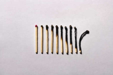 Burnt matchsticks on background in studio