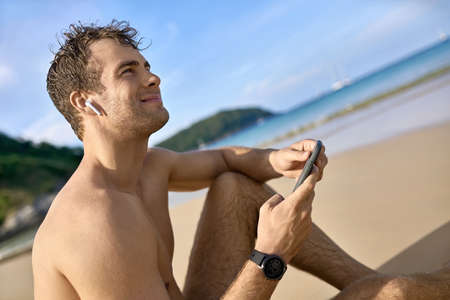 Tanned guy on beach. Daylight morning shooting.の写真素材