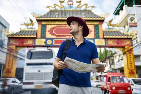 Traveler on asian city street. Daylight shooting.