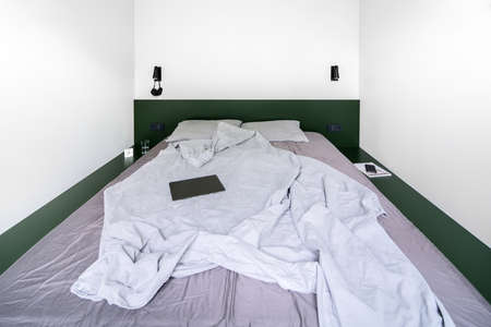 Stylish bedroom in modern style with white wallsの写真素材