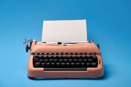 Retro typewriter coral color in studio, studio shoot.の写真素材