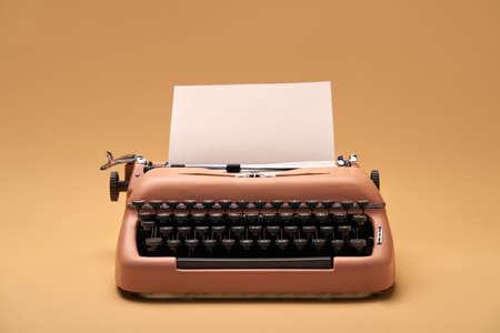Retro typewriter coral color in studio, studio shoot.の写真素材