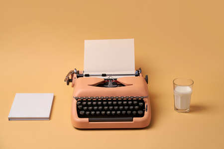 Composition with typewriter, book and glass. Studio shoot.の写真素材