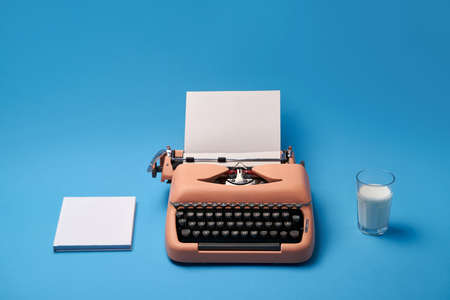 Composition with typewriter, book and glass. Studio shoot.の写真素材