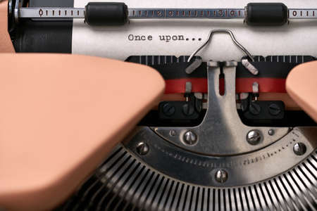 Vintage typewriter coral color in studio, close up.の写真素材