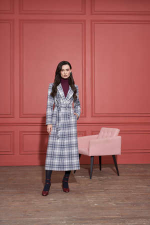 Model posing in studio in trendy clothesの写真素材