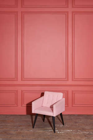 Nice soft pink armchair stands in studioの写真素材