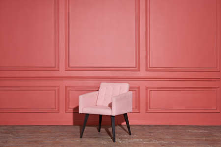 Nice soft pink armchair stands in studioの写真素材
