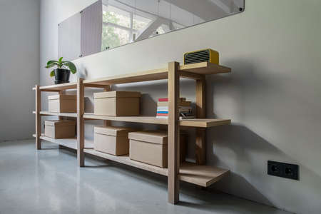 Stylish interior with wooden shelves and gray wallsの写真素材