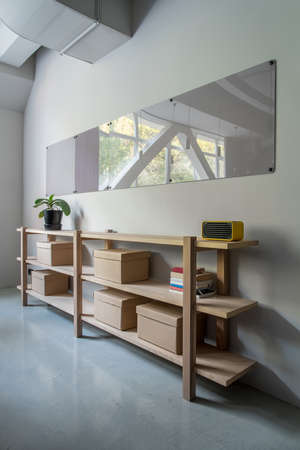 Stylish interior with wooden shelves and gray wallsの写真素材