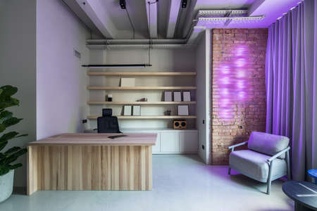 Stylish office in loft style with gray wallsの写真素材