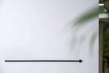Gray wall with a pointer on it in a luminous interior. Closeup low aperture photo. Horizontal.の写真素材