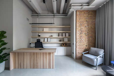 Stylish office in loft style with gray wallsの写真素材