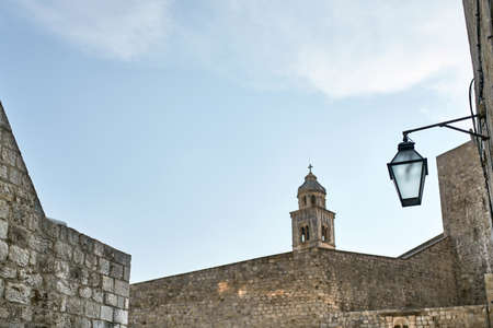 Old walls and bell tower in Dubrovnik in Croatiaの写真素材