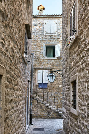 Old stone houses with windows with shutters in Budva in Montenegの写真素材