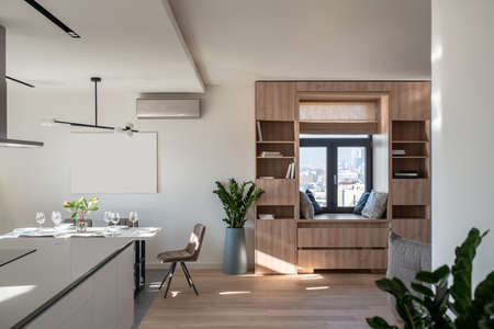 Sunny modern interior with white walls and kitchen zoneの写真素材