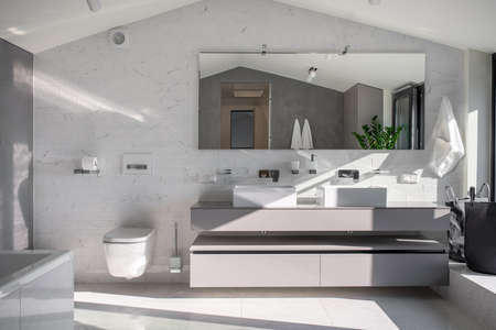 Sunny bathroom in modern style with light wallsの写真素材
