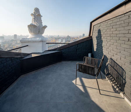 Cozy small terrace with brick walls on sunny cityscape backgrounの写真素材