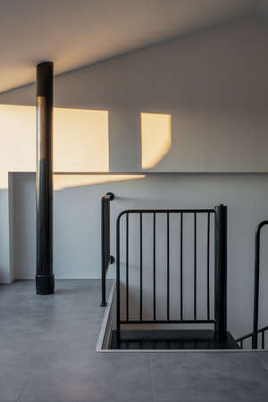 Sunny hall in modern style with black staircaseの写真素材