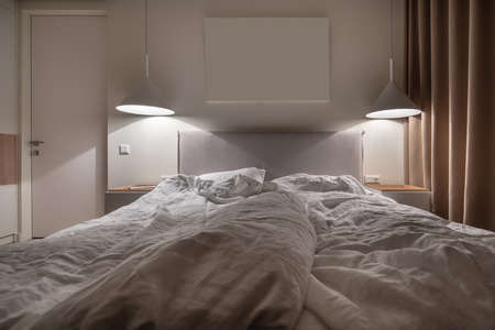 Stylish bedroom in modern style with luminous lampsの写真素材