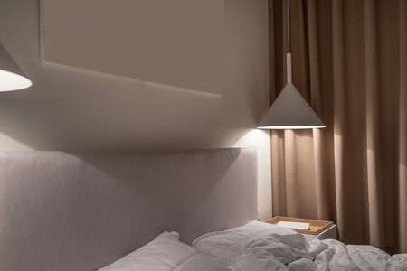 Stylish bedroom in modern style with luminous lampsの写真素材