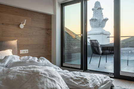 Sunny bedroom in modern style with exit to terraceの写真素材