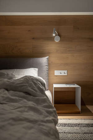 Stylish bedroom in modern style with luminous lampの写真素材