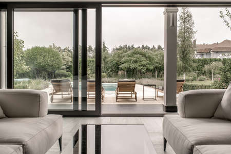 Modern interior with large glass door and windowsの写真素材