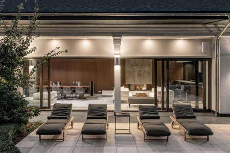 Few deck chairs on tiled terrace of luminous villaの写真素材