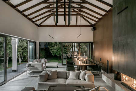 Illuminated interior with wooden beams and fireplaceの写真素材