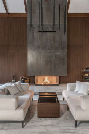 Modern interior with wooden wall and burning fireplaceの写真素材
