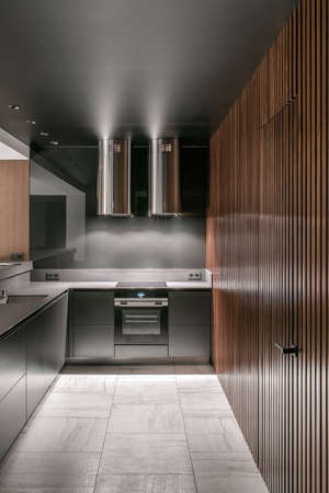 Luminous modern kitchen with glossy metallic surfacesの写真素材