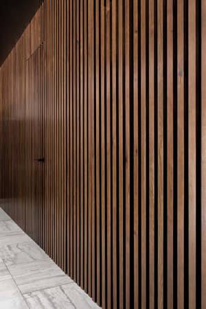 Illuminated interior with lattice wooden wall with doorの写真素材