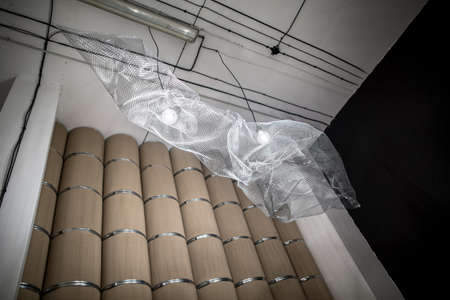 Hanging glowing lamps with the decorative net on the backgroundの写真素材