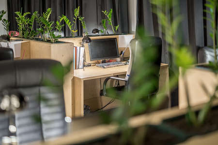 Office in loft style workplace with a wooden tableの写真素材