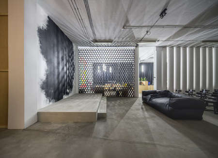 Loft style conference hall with a platform next to a white walの写真素材