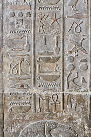 Ancient egyptian temple wall covered with hieroglyphics and imagの写真素材