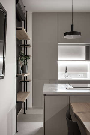 Kitchen in modern style with light walls and gray floor and illuminationの写真素材