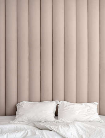 Stylish bedroom in modern style with brown textile wall panelの写真素材