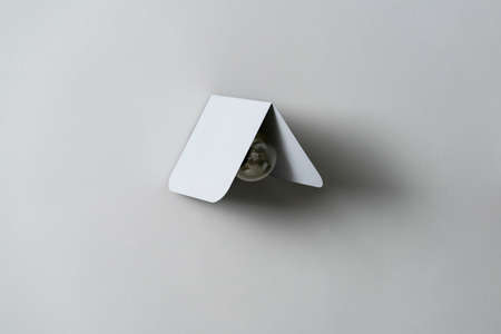Fancy gray metal lamp on wall in studioの写真素材