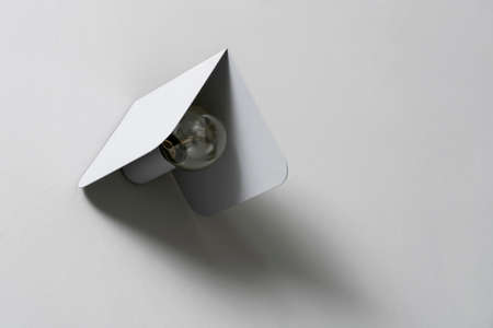 Fancy gray metal lamp on wall in studioの写真素材