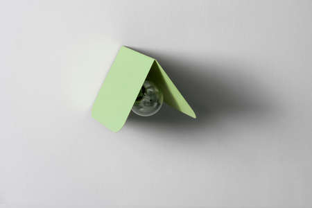 Fancy green metal lamp on gray wall in studioの写真素材